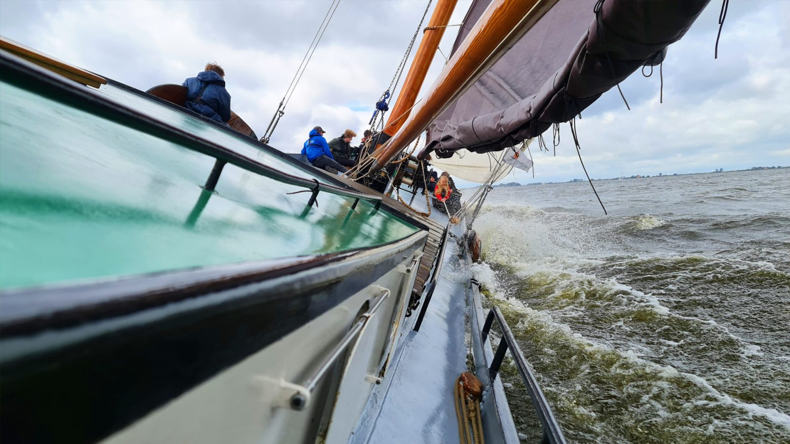 Sailing together with the team in Heeg during Skûtsjesilen with authentic racing skûtsjes.