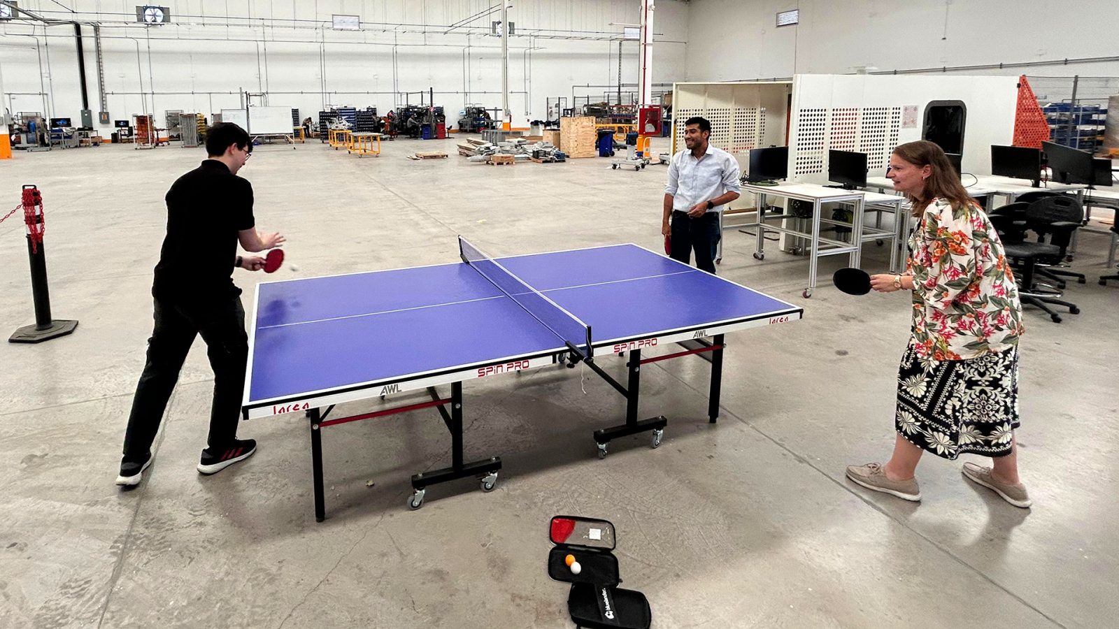 Carolina thoroughly enjoys a game of table tennis with her colleagues.