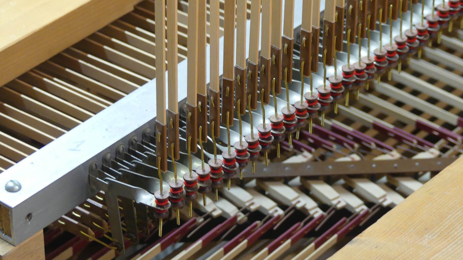 The connection between technology and music becomes literally visible here. You can see the mechanical connection that uses the keys to control the organ pipes.