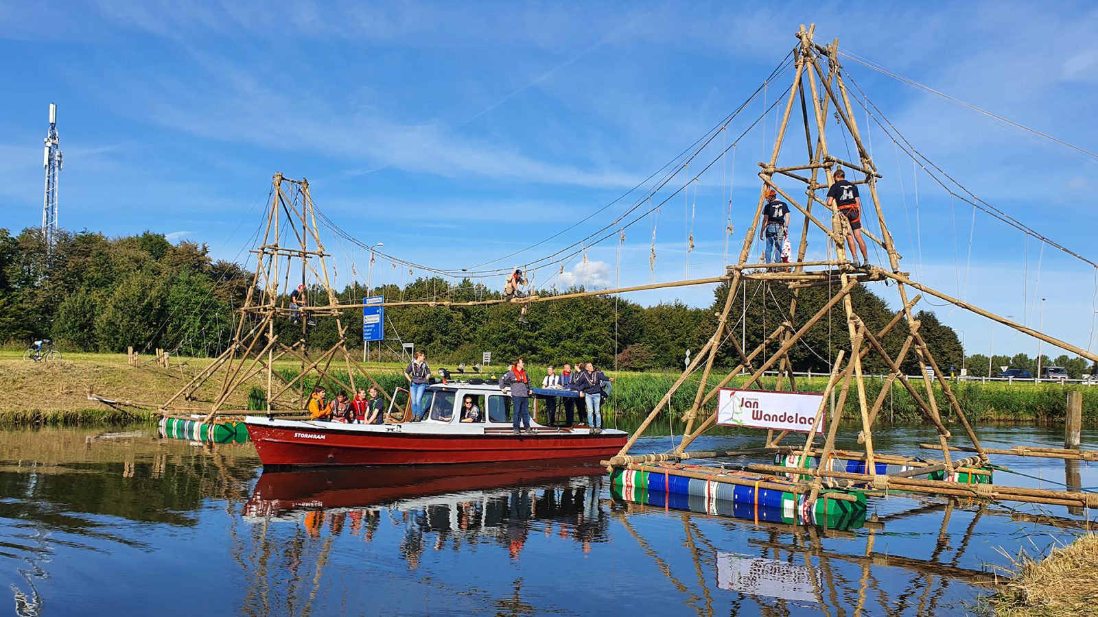 The 20-meter bridge over the water, allowing scouts to walk across while boats could still pass underneath. This required planning, permits, and calculations to ensure safety.
